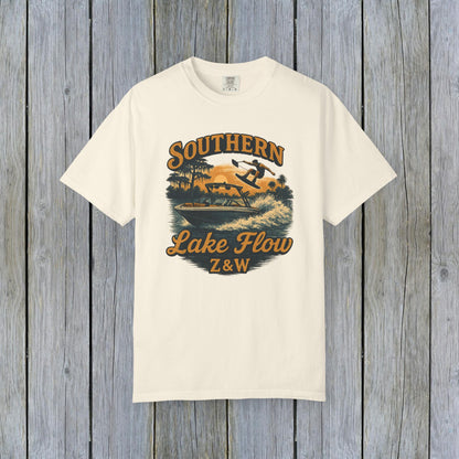 Southern Lake Flow T-Shirt in natural color, featuring a vibrant design of a person water skiing, made from eco-friendly 100% US cotton, available in sizes S to 4XL.