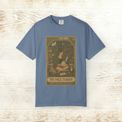 Page Turner Tarot Tee - Soft Cotton T-Shirt in a calming blue, featuring a playful graphic of a book lover in a cozy setting, perfect for tarot and literature fans.