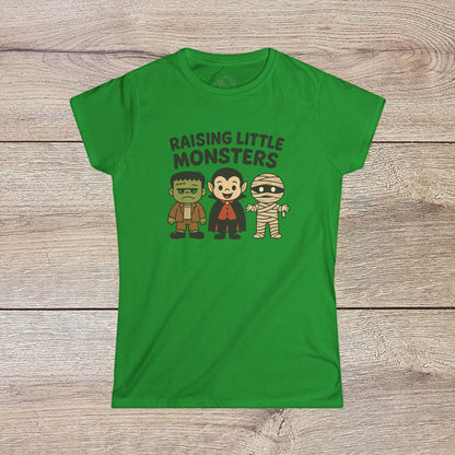 Vibrant green Halloween Family T-Shirt displaying fun cartoon characters of a monster, Dracula, and a mummy, featuring the phrase 'Raising Little Monsters'. Perfect kids tee for Halloween parties.