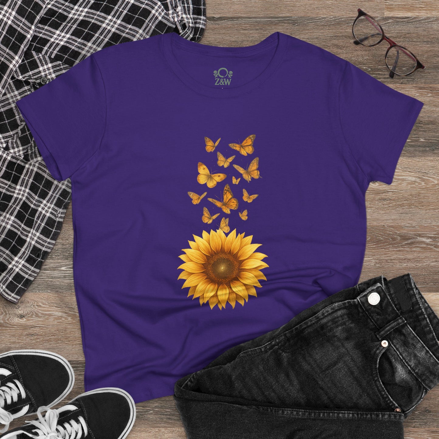 Sunflower & Butterflies Cotton Tee for Women - 100% Soft Cotton, Breathable, Durable Design, styled with a sunflower and butterflies, paired with black jeans and a plaid jacket.