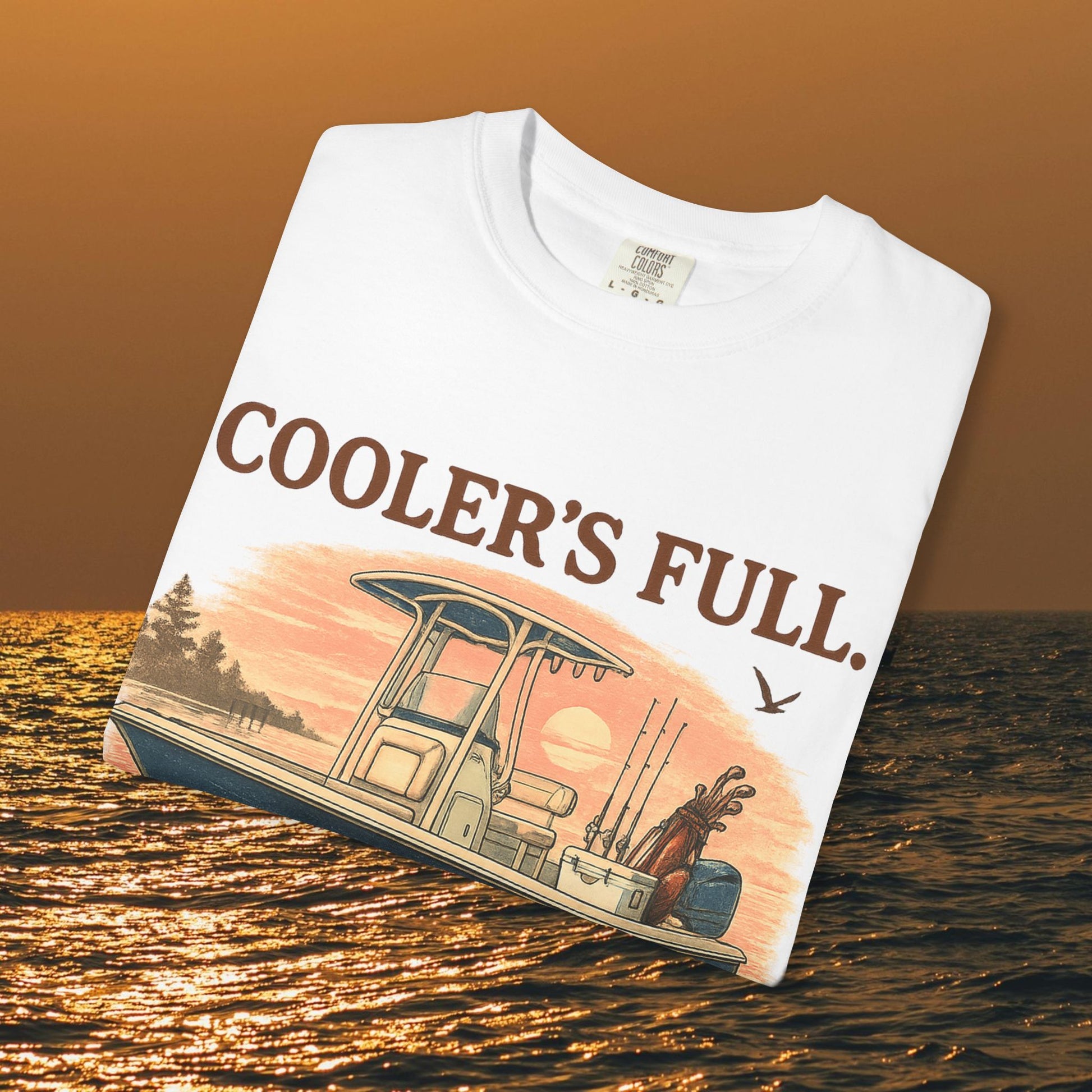 Folded Men's & Women's Durable Cotton Full Tee showcasing the printed graphic of a fishing boat with the text 'COOLER'S FULL.' illuminated by sunset colors, sizes S to 4XL.
