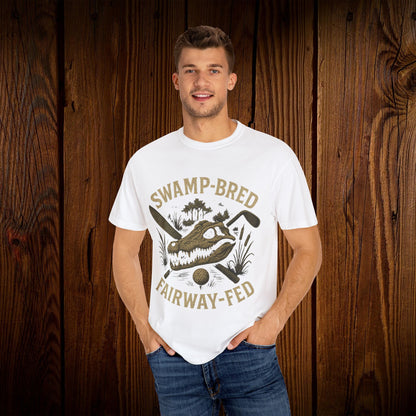 Model showcasing the Unisex Swamp-Bred Fairway-Fed Tee in white, emphasizing the eye-catching alligator graphic and relaxed fit for versatile styling.