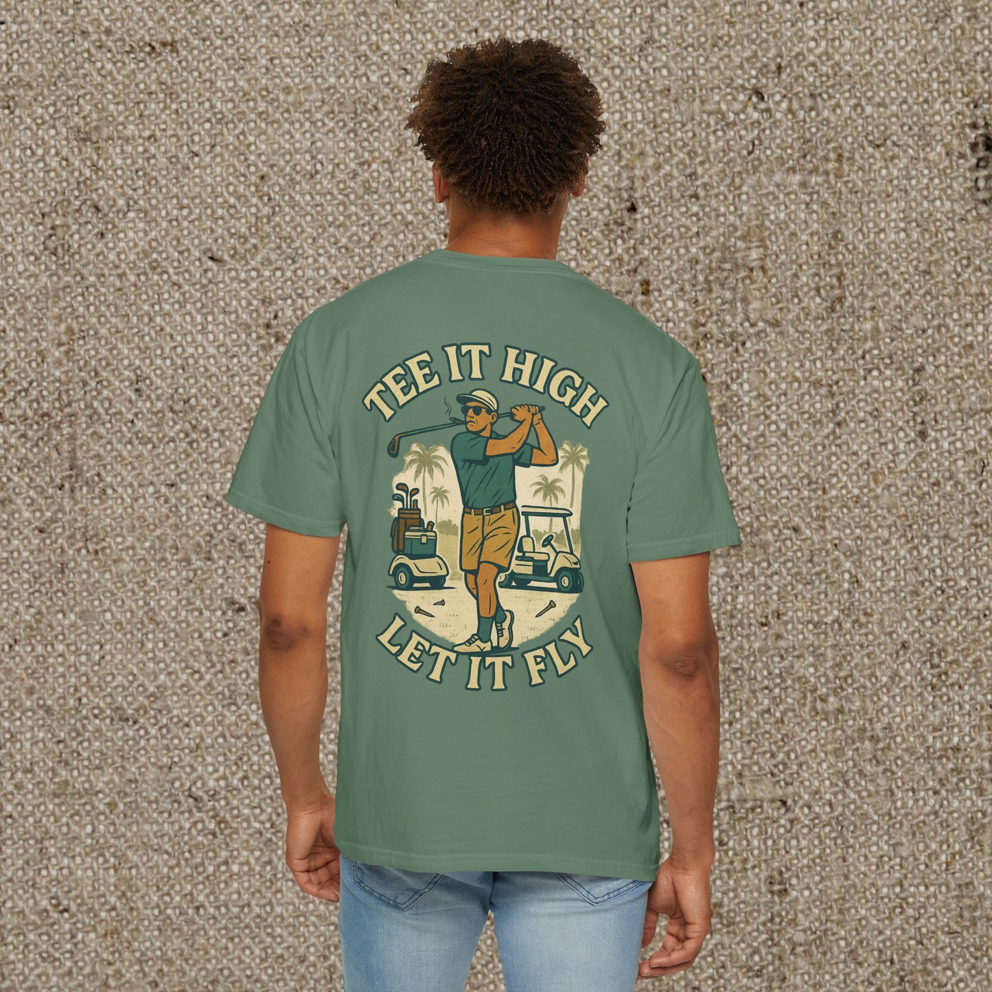 Back view of the 'Tee It High Let It Fly Graphic Tee' worn by a man, highlighting the golfer graphic, suitable for all occasions.