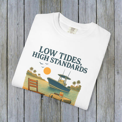 Flat lay of a white garment-dyed Low Tides High Standards T-Shirt featuring a colorful beach graphic, perfect for summer wear.