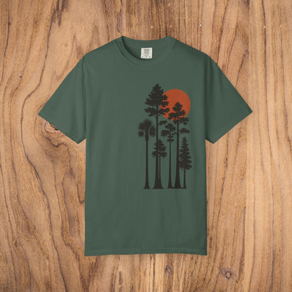 Sunset Trees Unisex T-Shirt in dark green, designed with a striking tree and sunset graphic, offering exceptional softness and a relaxed fit from 100% cotton.