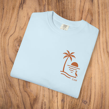 Unisex Sunset Palm Tree T-Shirt - Vibrant Garment-Dyed Cotton Tee for Men & Women in Light Blue featuring a unique palm tree and sunset graphic.