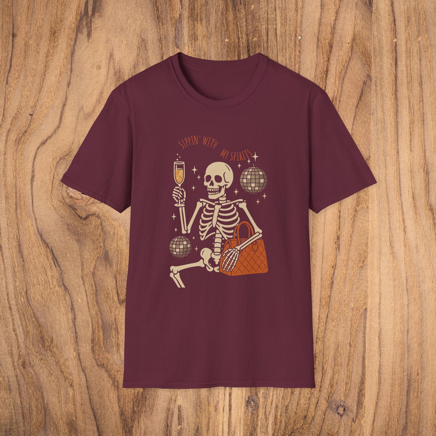 Spooky Spirits Graphic Tee in burgundy showcasing a cheerful skeleton with a drink, a great choice for Halloween wear.