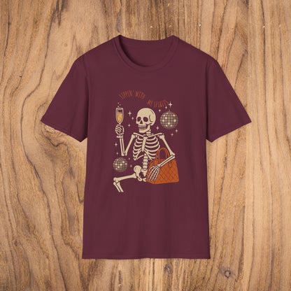 Spooky Spirits Graphic Tee in burgundy showcasing a cheerful skeleton with a drink, a great choice for Halloween wear.