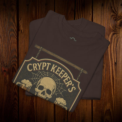 Crypt Keeper's Pub Tee in a rich brown color showcasing a unique skull graphic with a spiderweb, ideal for Halloween festivities and everyday casual attire. Crafted from 100% cotton for lasting quality.
