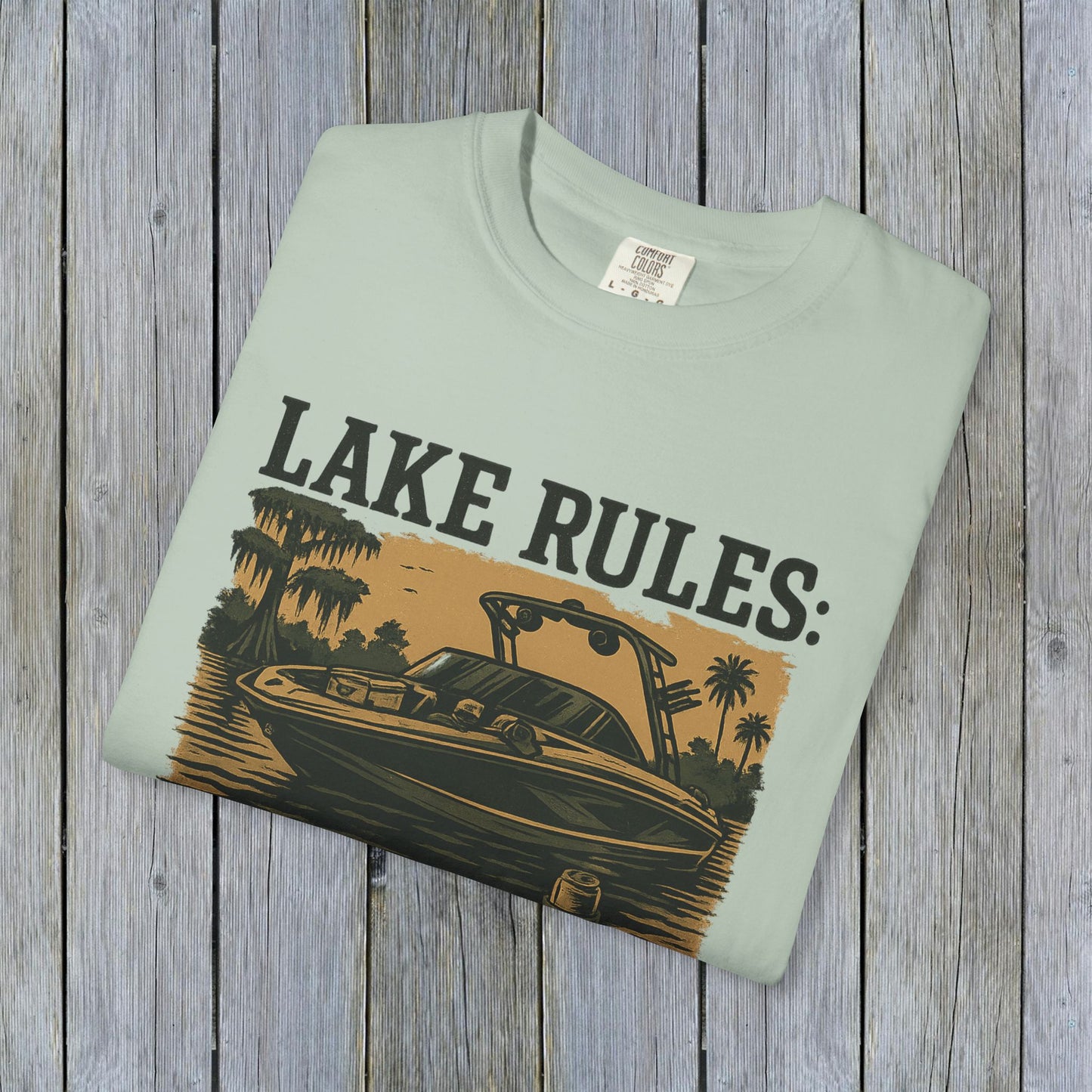 Front view of Unisex Garment-Dyed Lake Rules Tee featuring a stylish boat graphic with 'Lake Rules:' text, perfect for summer outings.