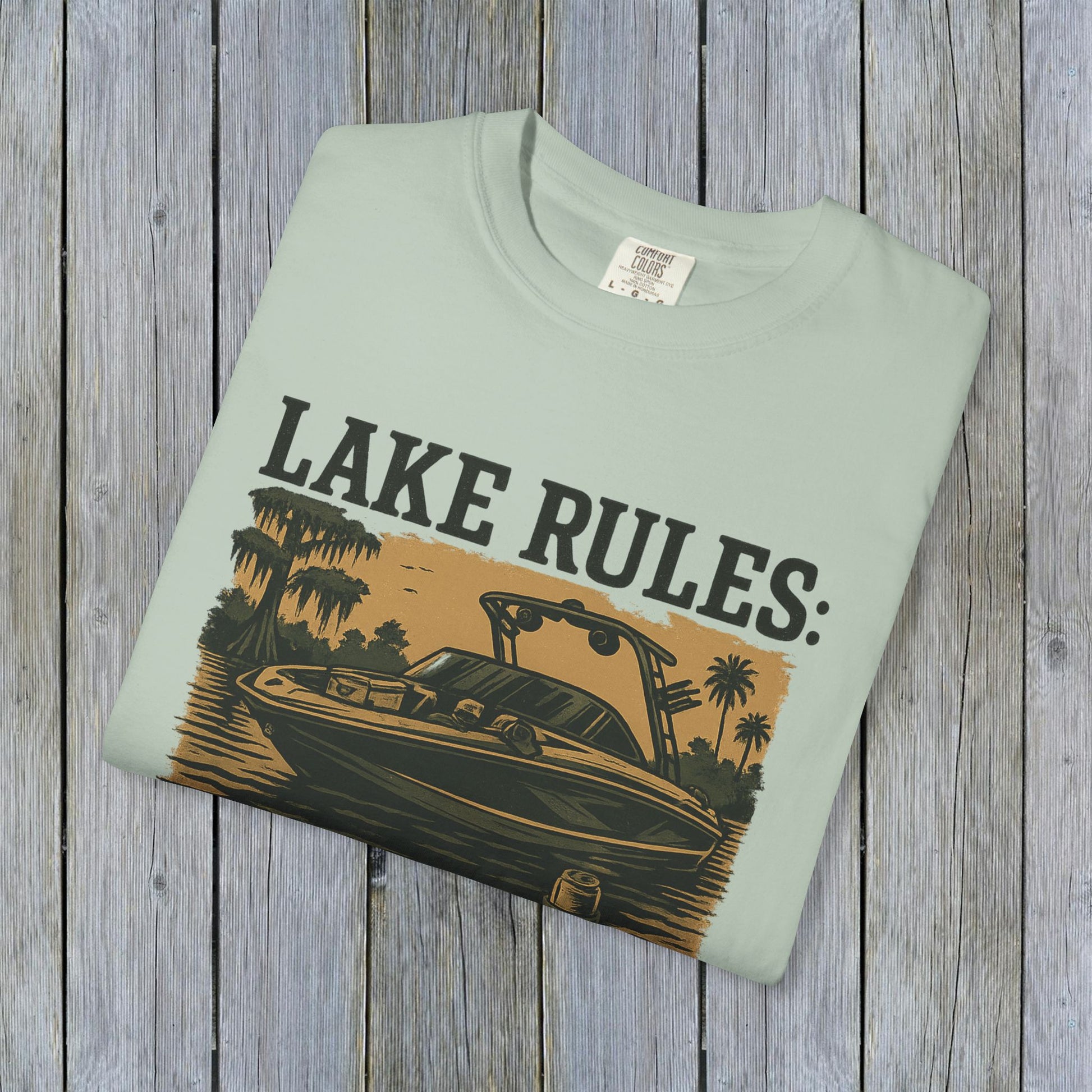 Front view of Unisex Garment-Dyed Lake Rules Tee featuring a stylish boat graphic with 'Lake Rules:' text, perfect for summer outings.