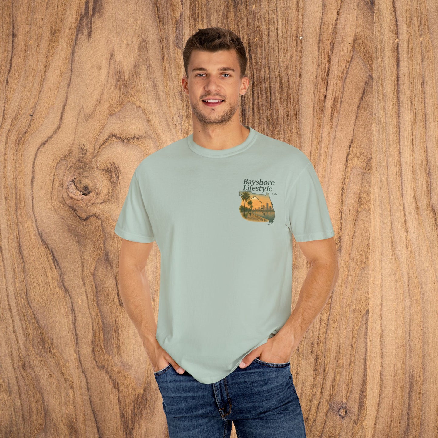 Man confidently modeling the Bayshore Lifestyle Tee in mint green, featuring a trendy pocket print, perfect for an everyday look.