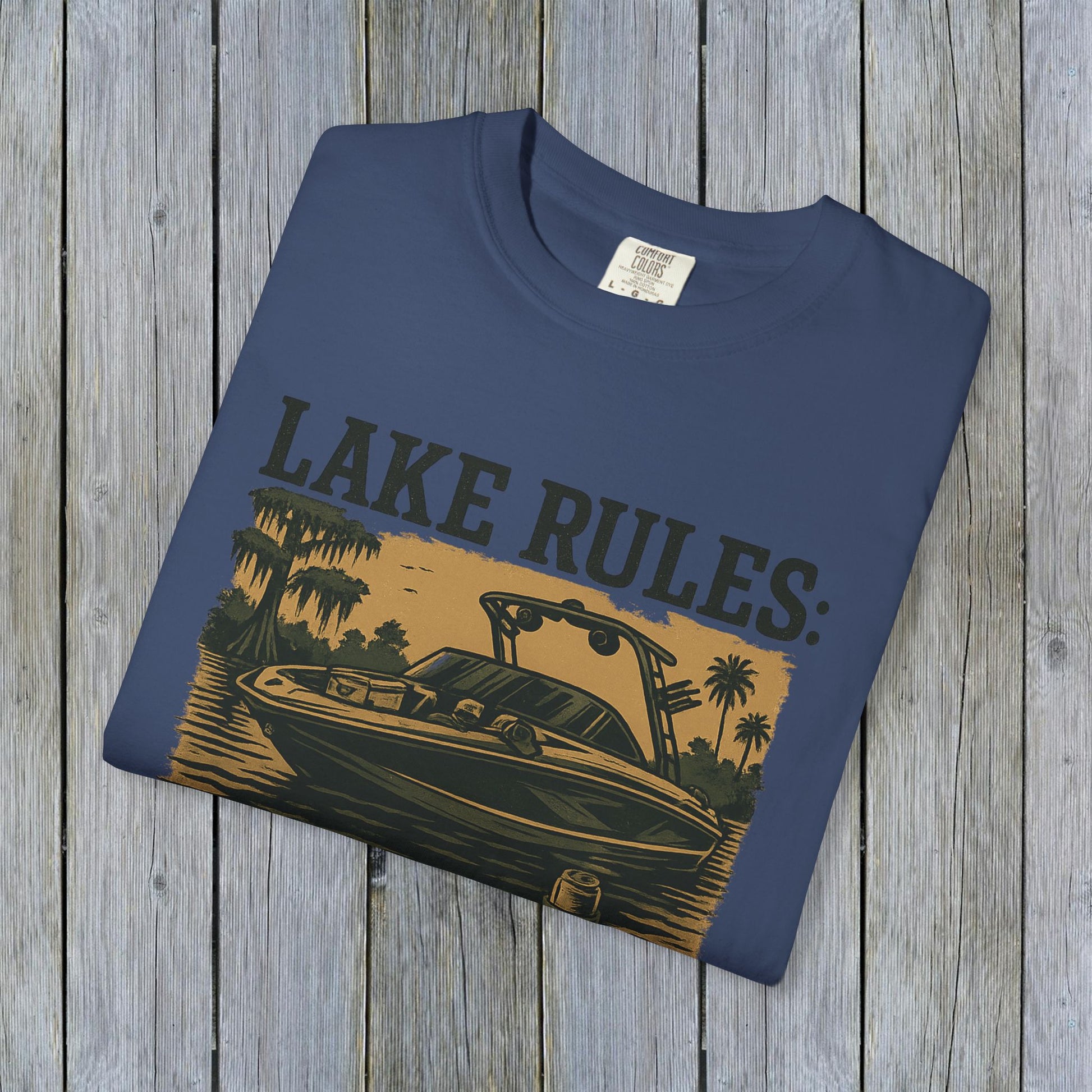 Unisex Garment-Dyed Lake Rules Tee displayed flat, featuring a unique boat graphic, perfect for outdoor enthusiasts and casual outings.