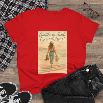 Southern Soul Coated Heart Tee in red on a wooden surface, featuring a charming illustration of a woman by the waterfront. A great addition to any casual wardrobe, perfect for expressing your coastal soul.