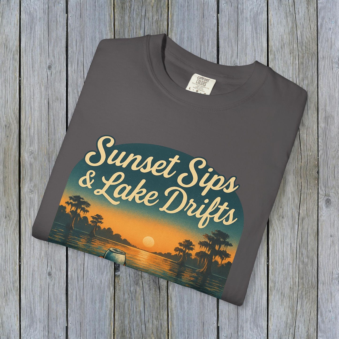 Lake Drifts T-Shirt in dark gray displaying 'Sunset Sips & Lake Drifts' graphic, a stylish choice for comfort.