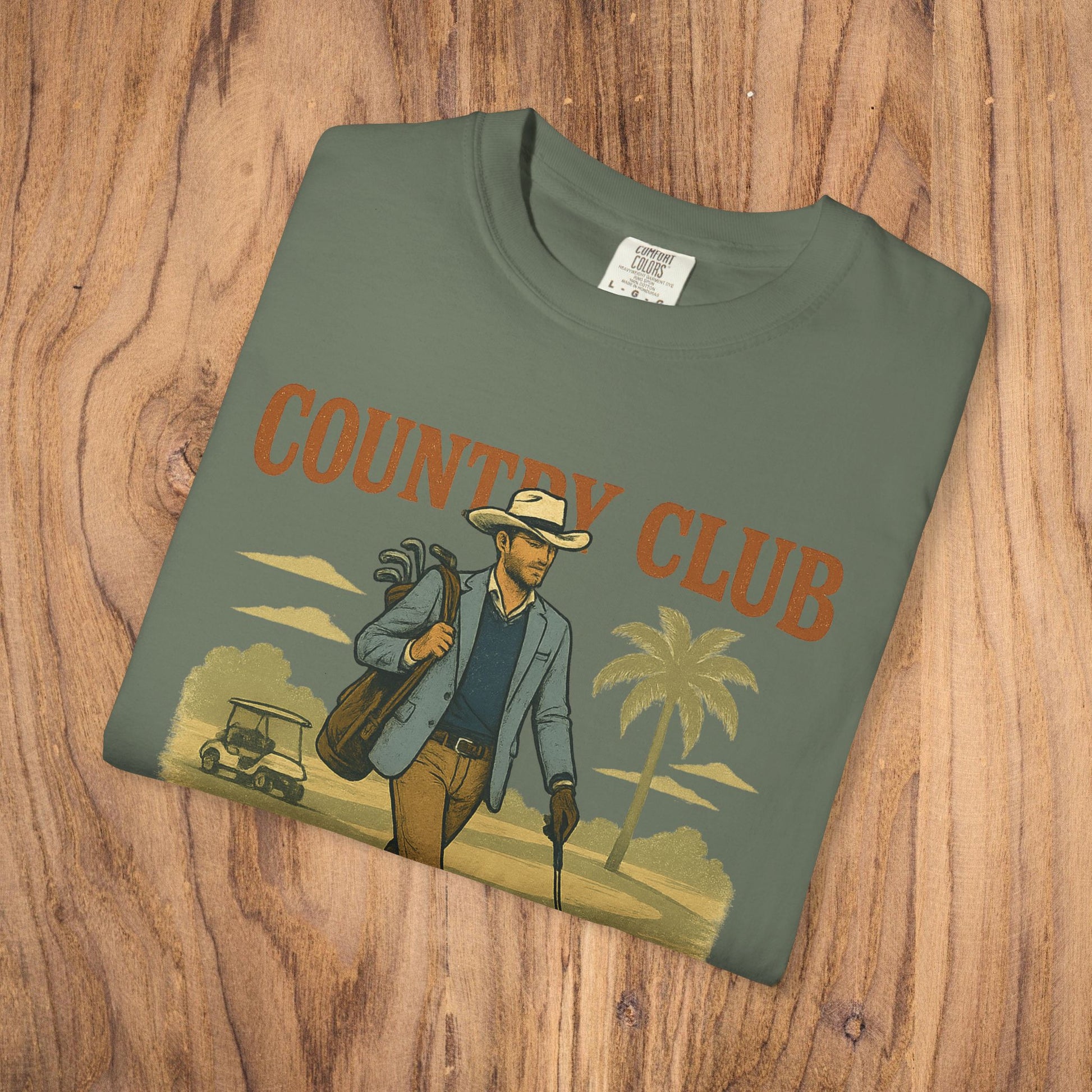 Front view of the Country Club Cowboy Graphic Tee in olive green, featuring a vibrant cowboy design and made from sustainable cotton.