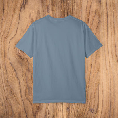 Back view of Country Club Cowboy Graphic Tee on rustic wooden background, showcasing its spacious and minimalist design.
