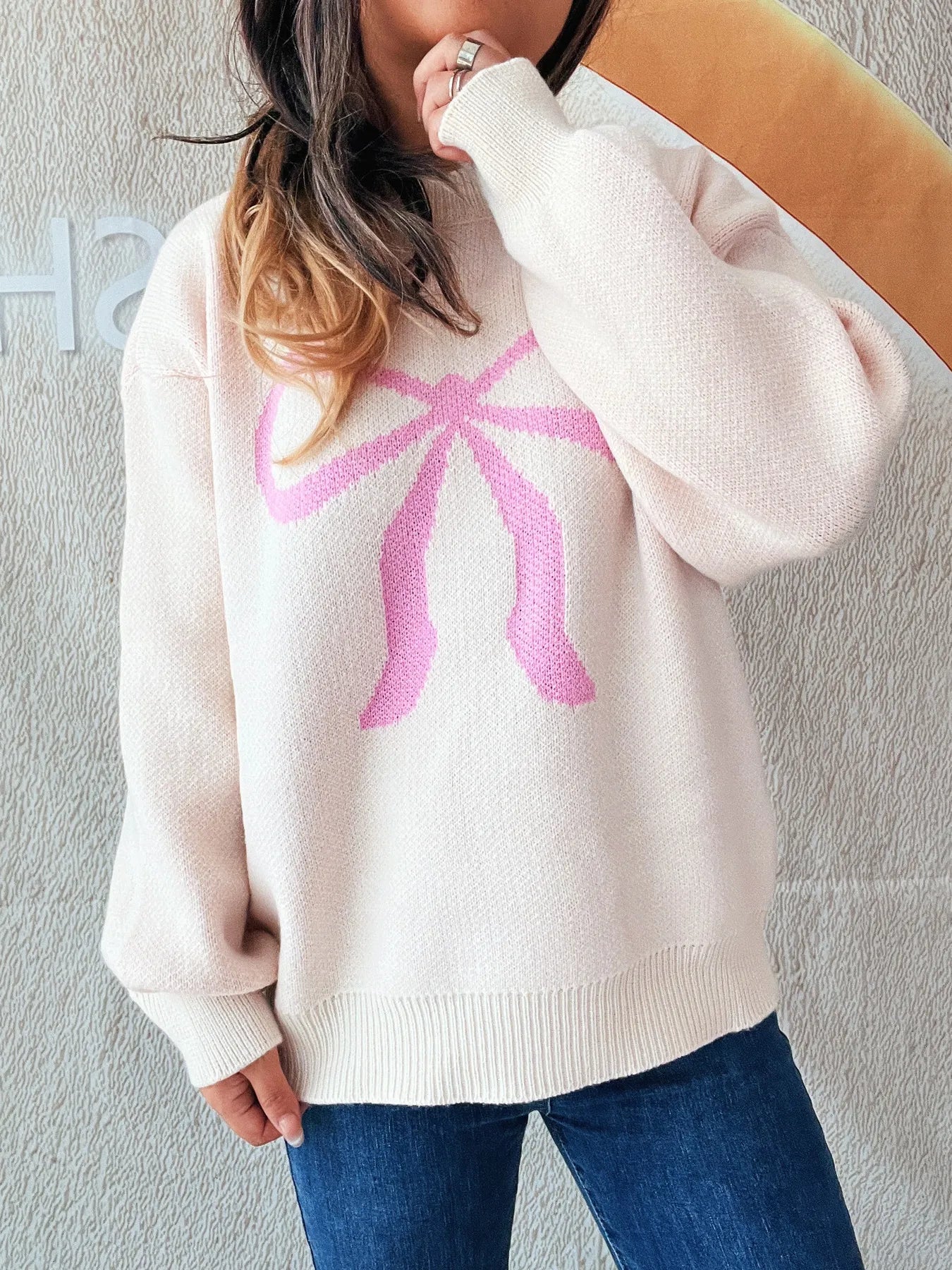Stylish Bow Pattern Casual Long Sleeve Sweater for Effortless Everyday Wear, presenting a cozy fit with a distinctive pink bow, suitable for daily fashion.