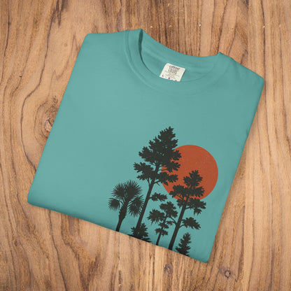 Folded Sunset Trees Unisex T-Shirt featuring a vibrant tree and sun design, made from soft 100% cotton, perfect for nature lovers seeking stylish comfort.