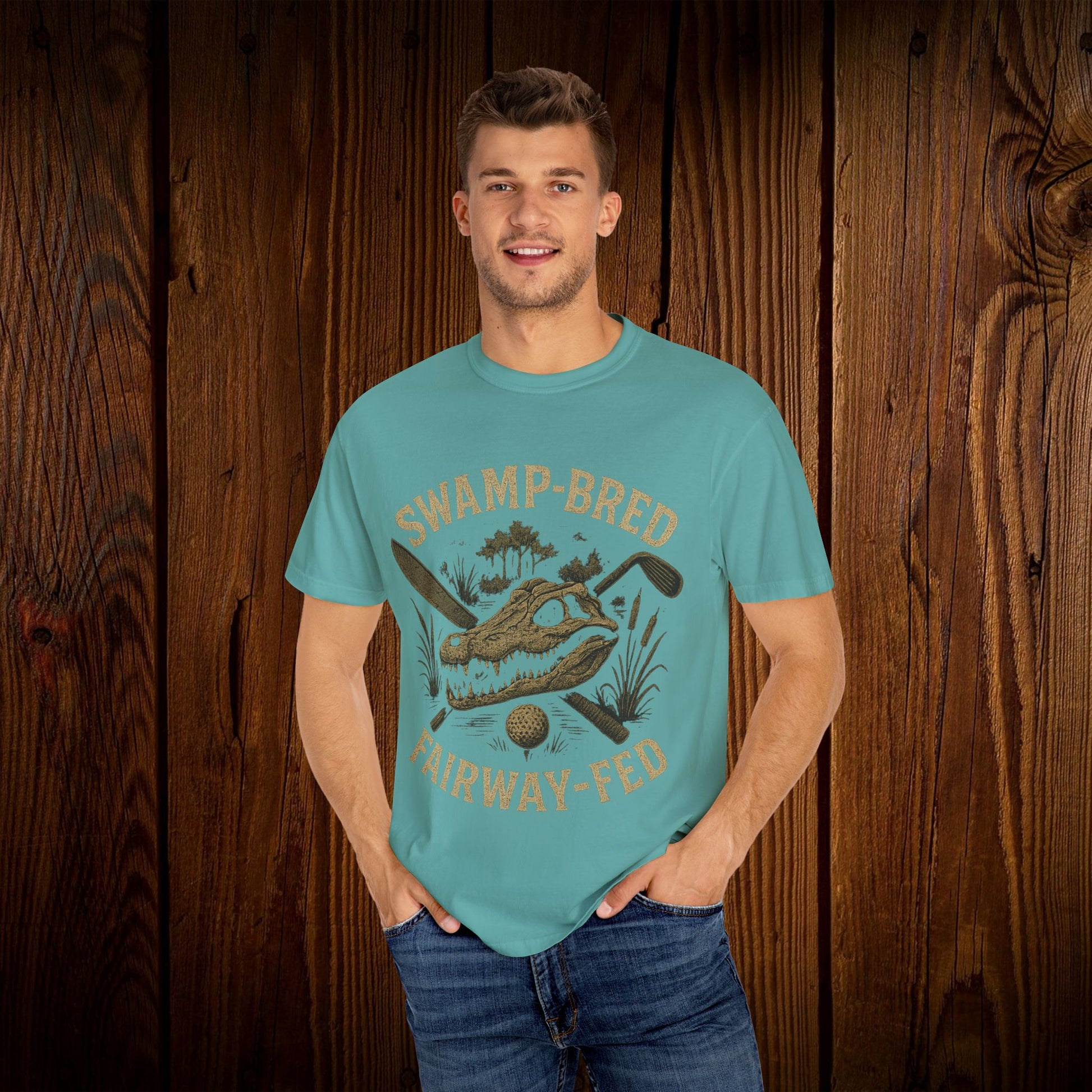 Model wearing the Unisex Swamp-Bred Fairway-Fed Tee in turquoise, highlighting its vibrant color and stylish print, perfect for casual outings.