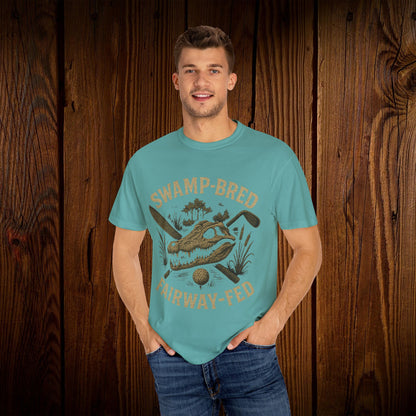 Model wearing the Unisex Swamp-Bred Fairway-Fed Tee in turquoise, highlighting its vibrant color and stylish print, perfect for casual outings.