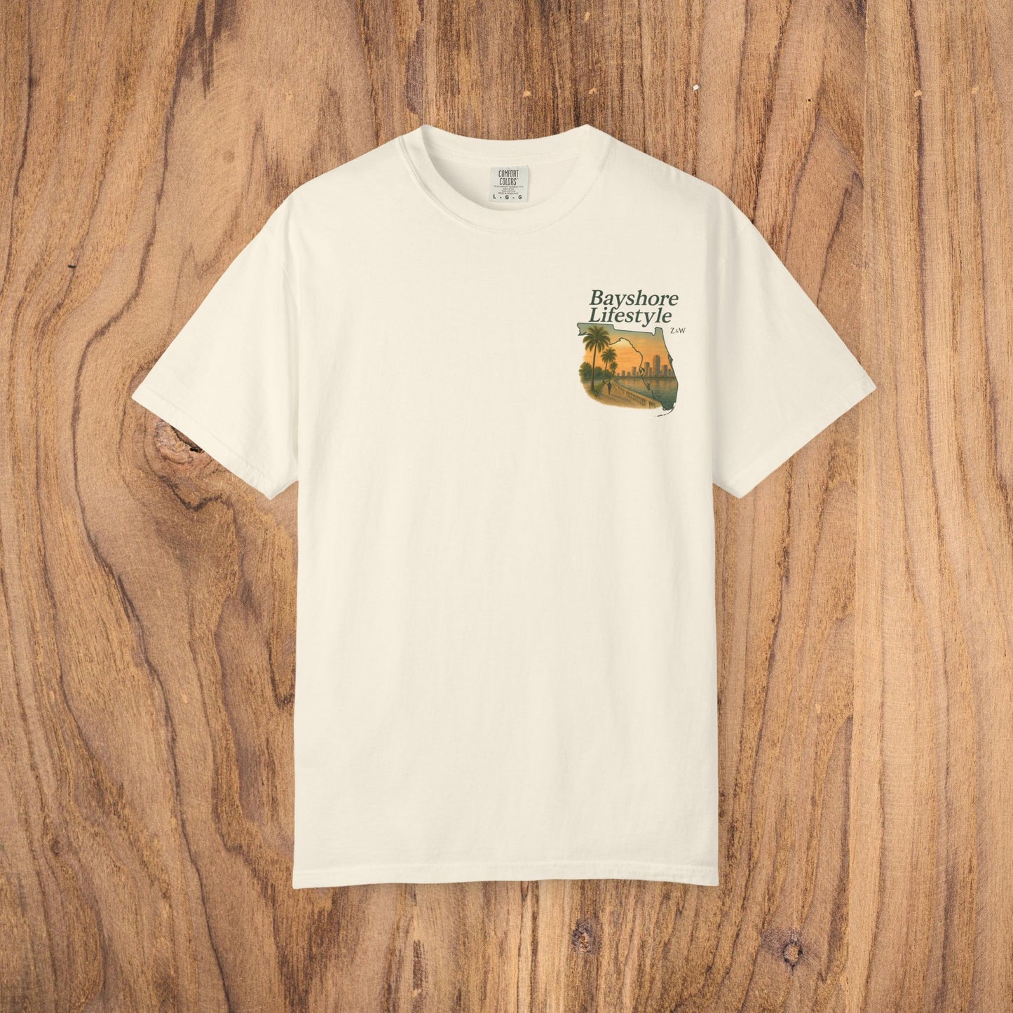 Bayshore Lifestyle Tee presented in an elegant cream color, highlighting its premium 100% cotton construction and unique print.