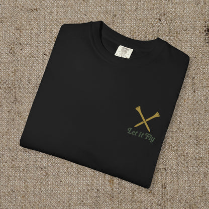 Folded Tee It High Let It Fly Graphic Tee showcasing a minimalist design with crossed golf clubs and the phrase 'Let it Fly', ideal for casual wear.