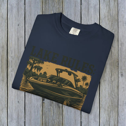 Front view of the folded Unisex Garment-Dyed Lake Rules Tee with a boat graphic, perfect for lake lovers and outdoor enthusiasts.