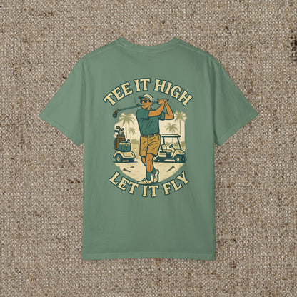 Back view of the 'Tee It High Let It Fly Graphic Tee', featuring a golfer in action against a golf course background, designed for style and comfort.