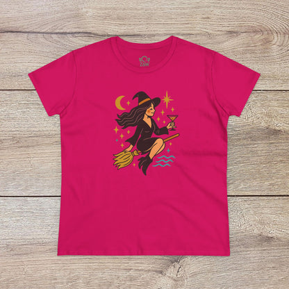 Witchy Night Out Tee displayed in bright pink showcasing a playful witch with a martini on her broomstick against a starry background, made from ethical and sustainable materials.