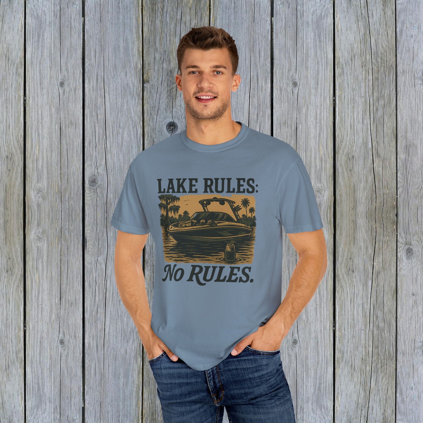 Unisex Garment-Dyed Lake Rules Tee - Soft Vintage Fabric, Sizes S to 4XL, perfect for outdoors, displayed on a male model in a relaxed fit with a scenic wooden background.