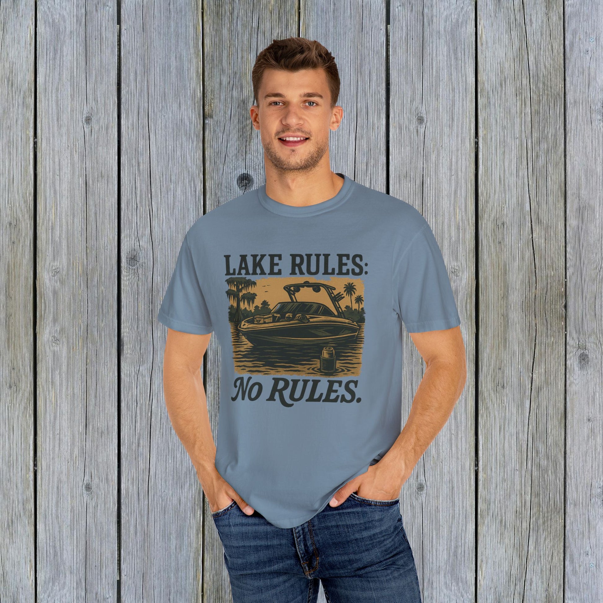 Unisex Garment-Dyed Lake Rules Tee - Soft Vintage Fabric, Sizes S to 4XL, perfect for outdoors, displayed on a male model in a relaxed fit with a scenic wooden background.
