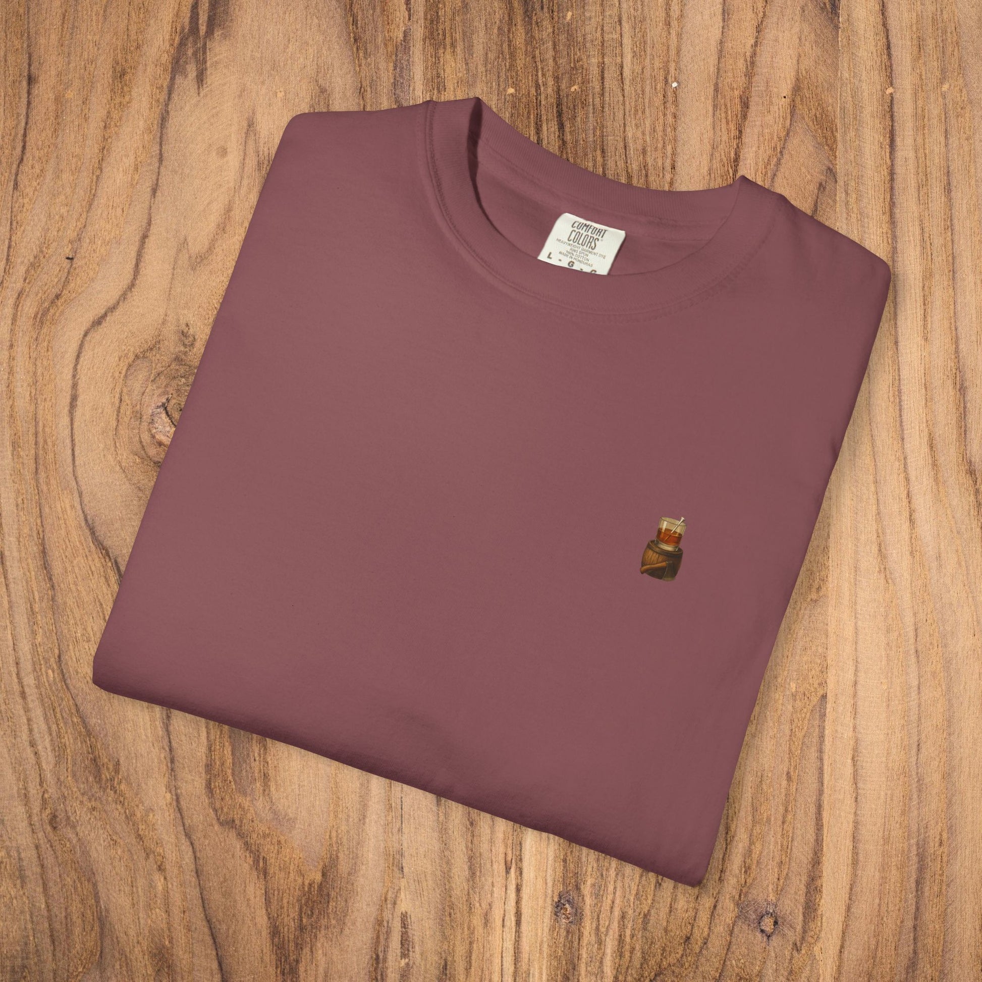 A folded Premium Southern Made T-Shirt in maroon color, highlighting its stylish design and high-quality fabric.