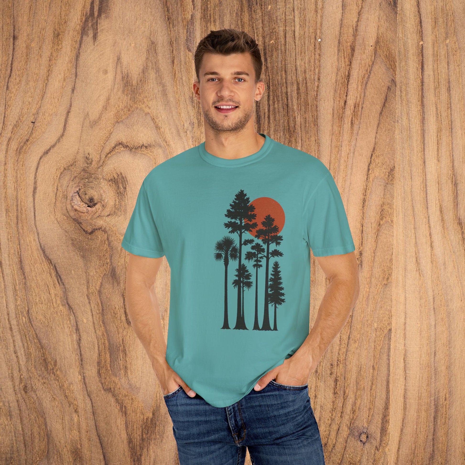 Front view of the Sunset Trees Unisex T-Shirt on a model, showcasing a tranquil nature-inspired graphic, made from soft 100% cotton for everyday wear.