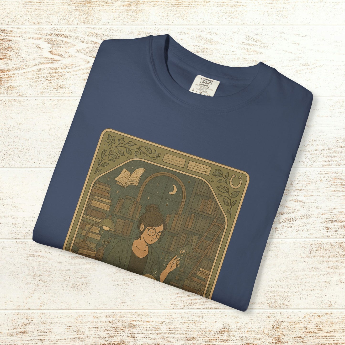 Page Turner Tarot Tee in navy, soft cotton t-shirt featuring a unique design of a woman reading in a library, available in sizes S to 4XL, eco-friendly and comfortable.