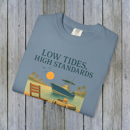 Garment-Dyed Low Tides High Standards T-Shirt in light blue, displaying a serene beach scene with a boat and sunset, offering comfort and style.