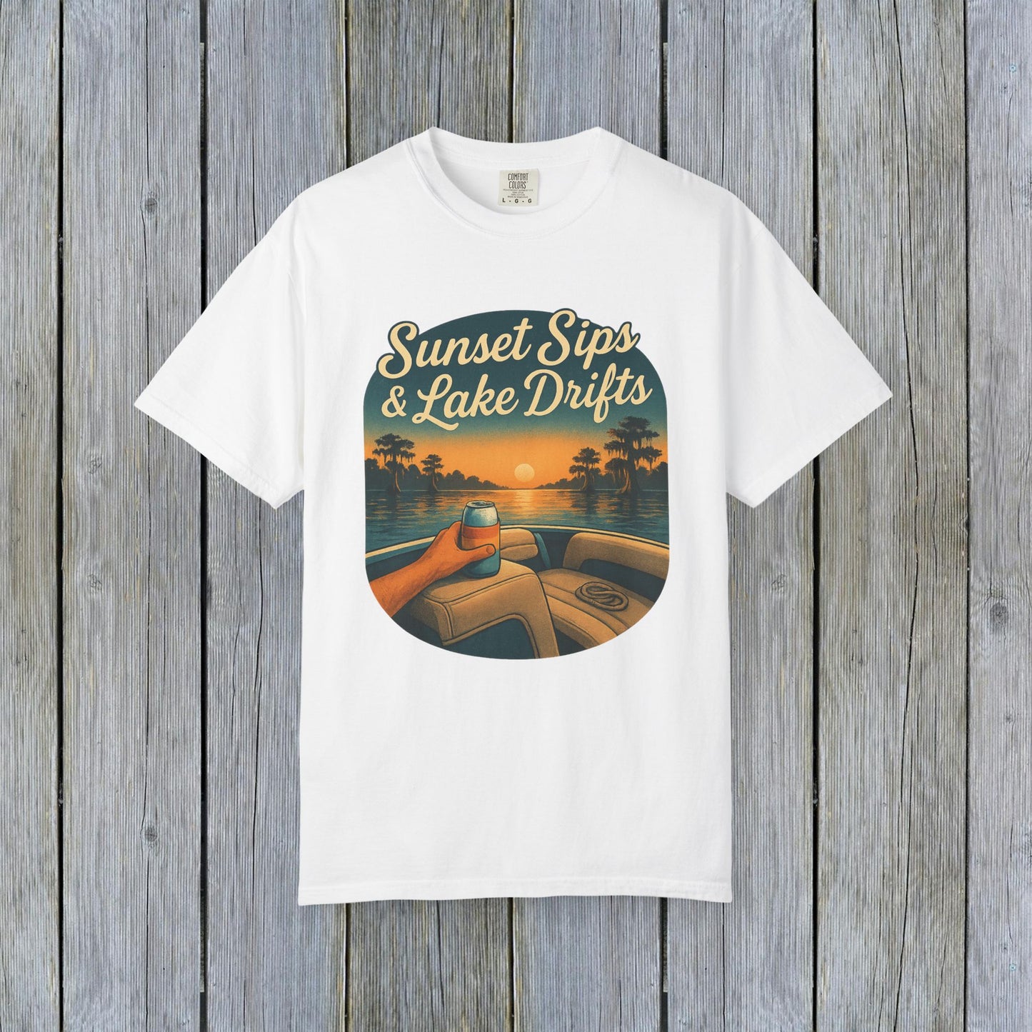 Lake Drifts T-Shirt in classic white displaying a sunset scene with a hand holding a beverage, perfect for casual style.