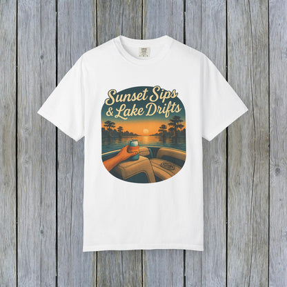 Lake Drifts T-Shirt in classic white displaying a sunset scene with a hand holding a beverage, perfect for casual style.
