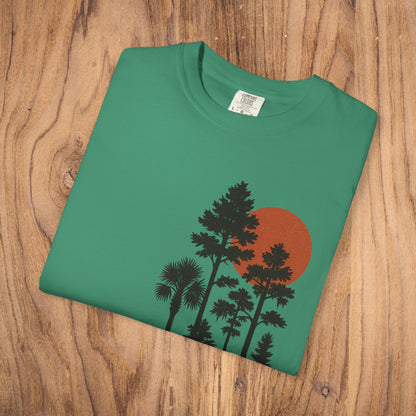 Front laid flat view of the Sunset Trees Unisex T-Shirt featuring a striking sunset design on a green background, made from high-quality 100% cotton.