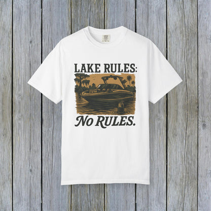Unisex Garment-Dyed Lake Rules Tee laid flat against weathered wood, highlighting the iconic lake design and relaxed fit, perfect for summer adventures.