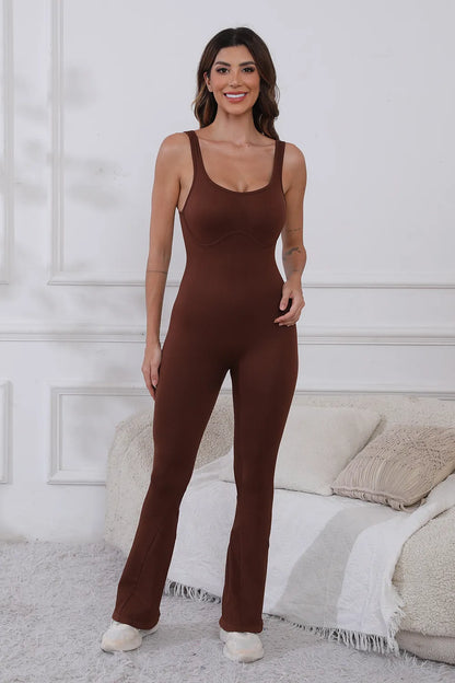 Scoop Neck Wide Strap Active Jumpsuit with Moderate Stretch - Comfortable & Stylish Fitness Wear. Model posing confidently in a brown jumpsuit, showcasing the stylish design and comfortable fit.