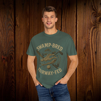 Model wearing the Unisex Swamp-Bred Fairway-Fed Tee in earthy green, featuring a unique graphic design that highlights the golf theme, providing a comfortable fit.