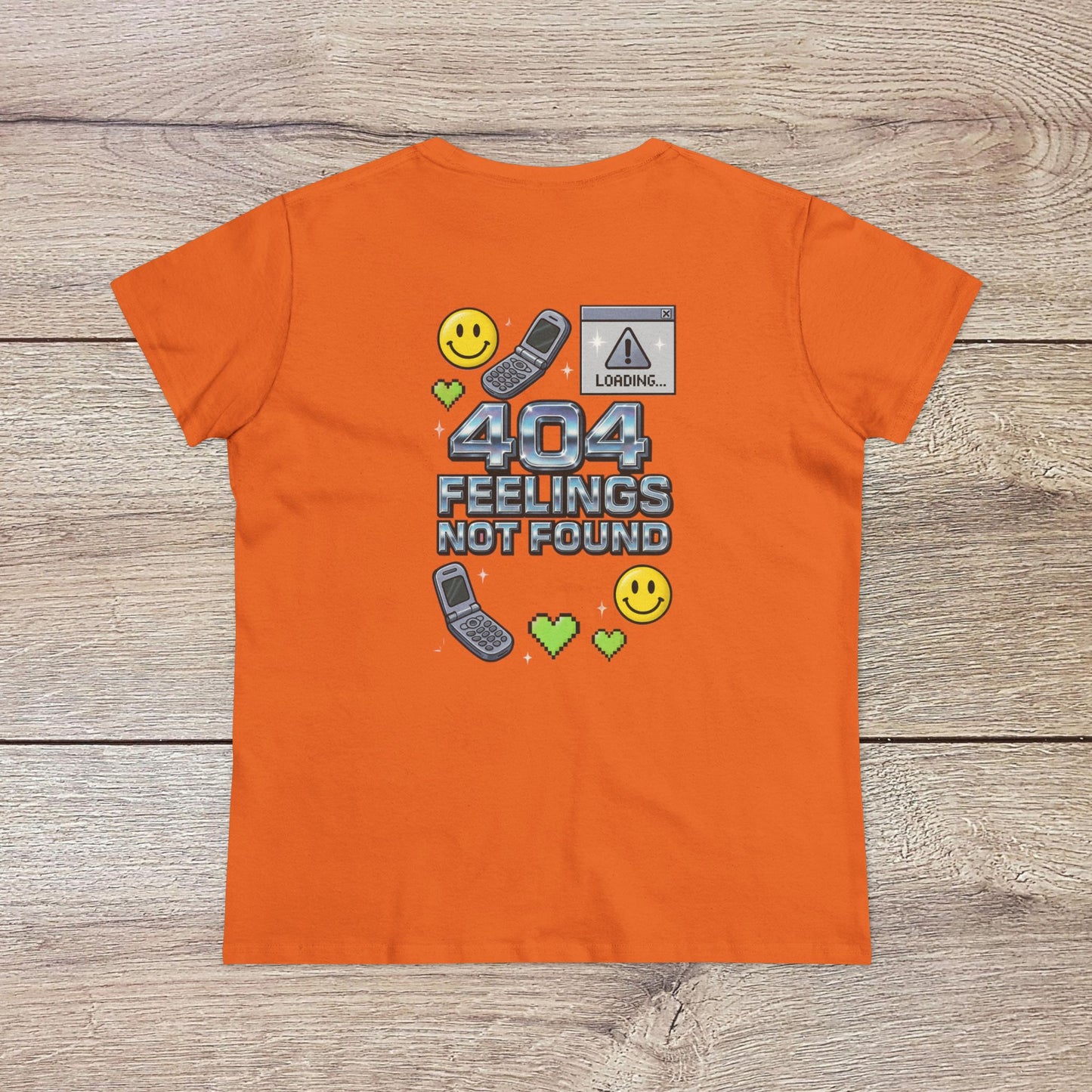 404 Y2K Graphic T-Shirt in bright orange featuring a fun '404 FEELINGS NOT FOUND' design with smiley faces and retro technology icons. A vibrant addition to any Y2K-inspired outfit.