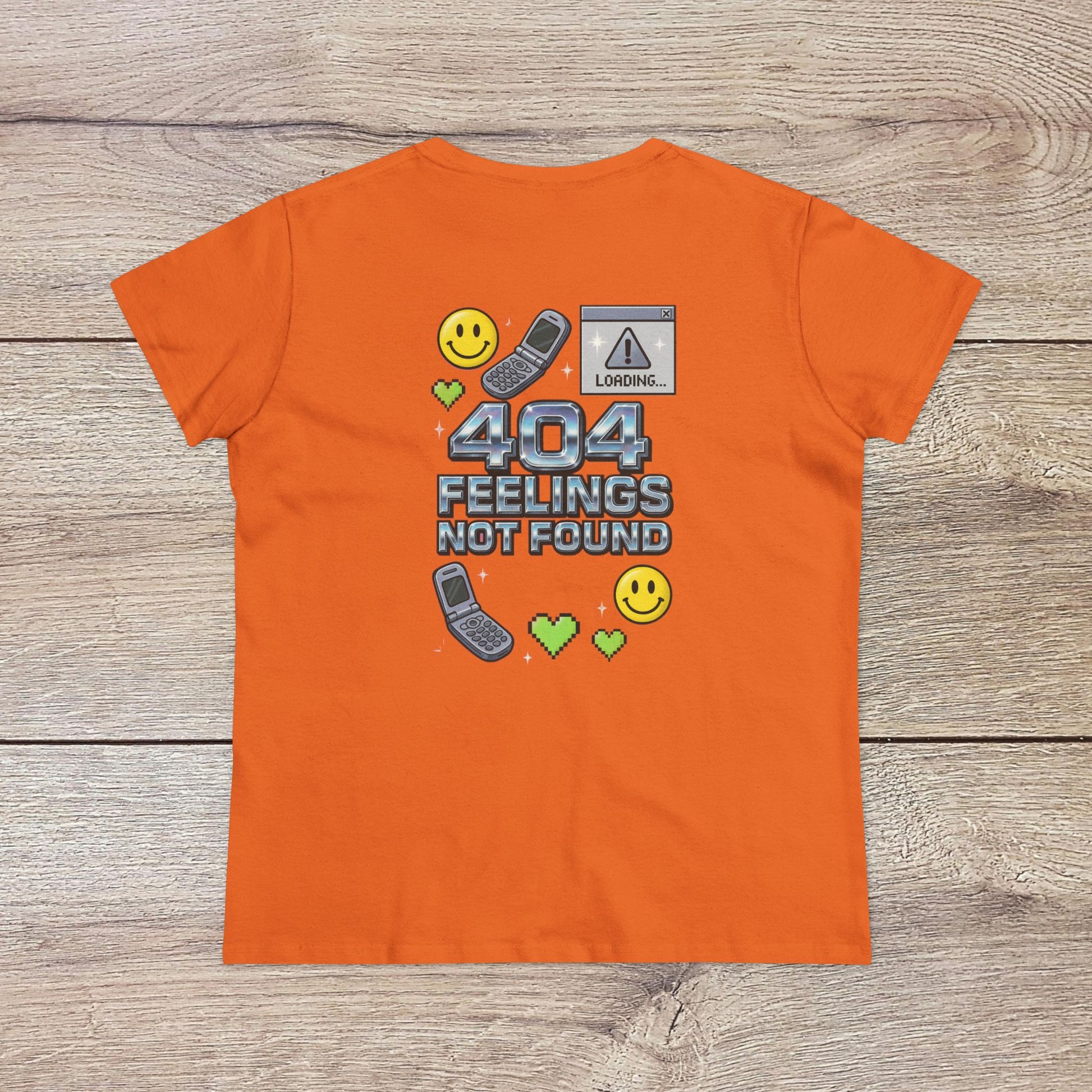 404 Y2K Graphic T-Shirt in bright orange featuring a fun '404 FEELINGS NOT FOUND' design with smiley faces and retro technology icons. A vibrant addition to any Y2K-inspired outfit.