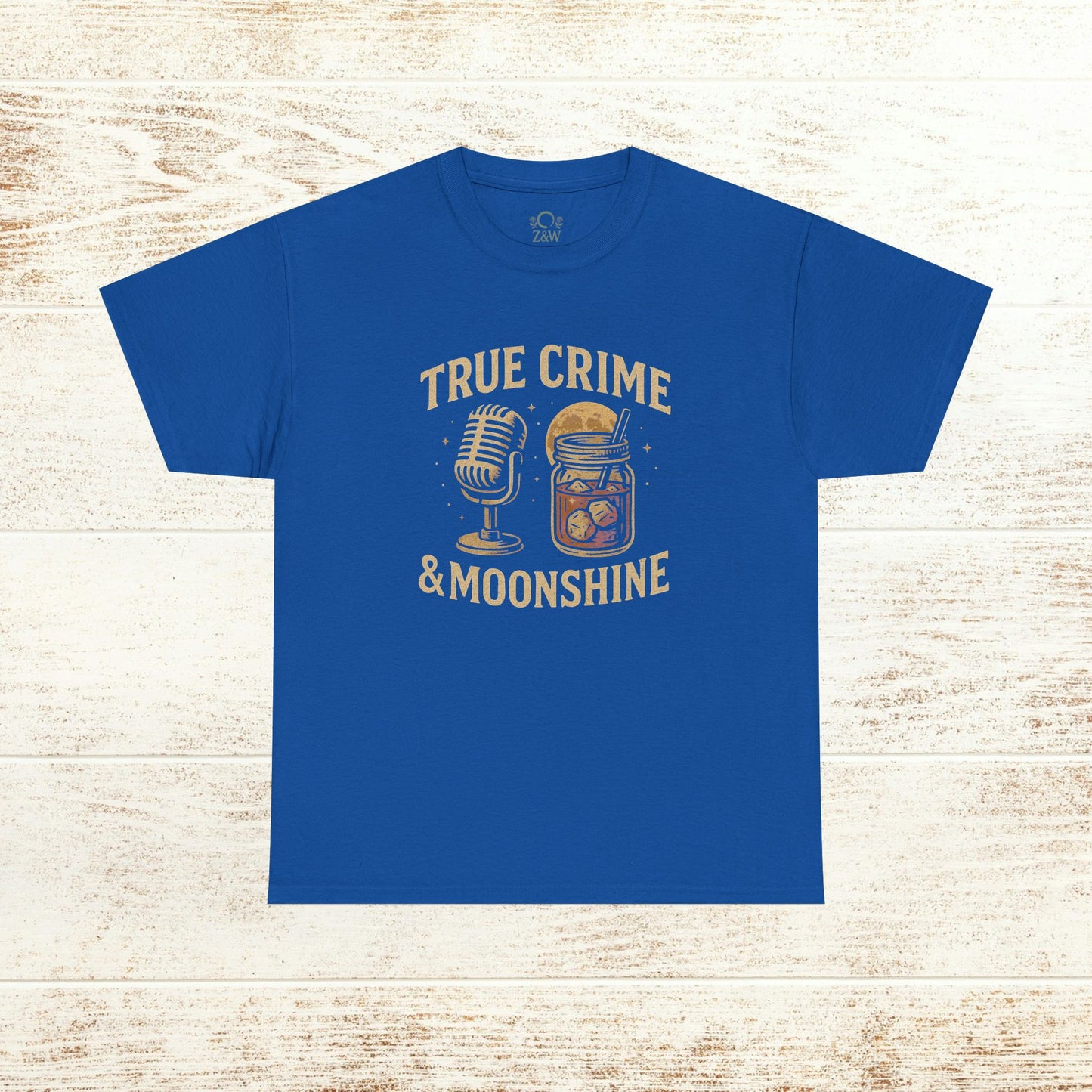 True Crime & Moonshine Unisex Graphic Tee - Vintage Casual Wear for True Crime Lovers displaying a vibrant design of a microphone and moonshine jar on a blue fabric.