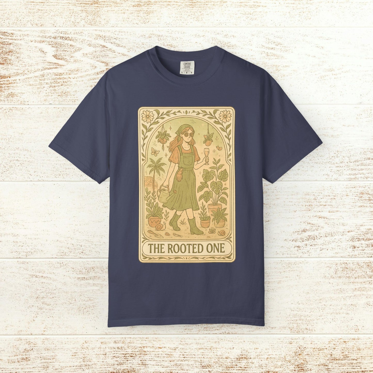Rooted One Tarot Tee in navy color, showcasing a captivating tarot design with a woman and botanical elements, crafted from ethically sourced cotton.