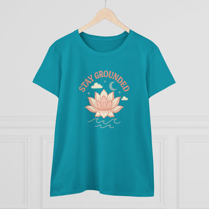 Front view of Stay Grounded Spiritual Tee in turquoise, featuring a lotus design, perfect for summer festivals and casual outings, hanging on a wooden hanger.