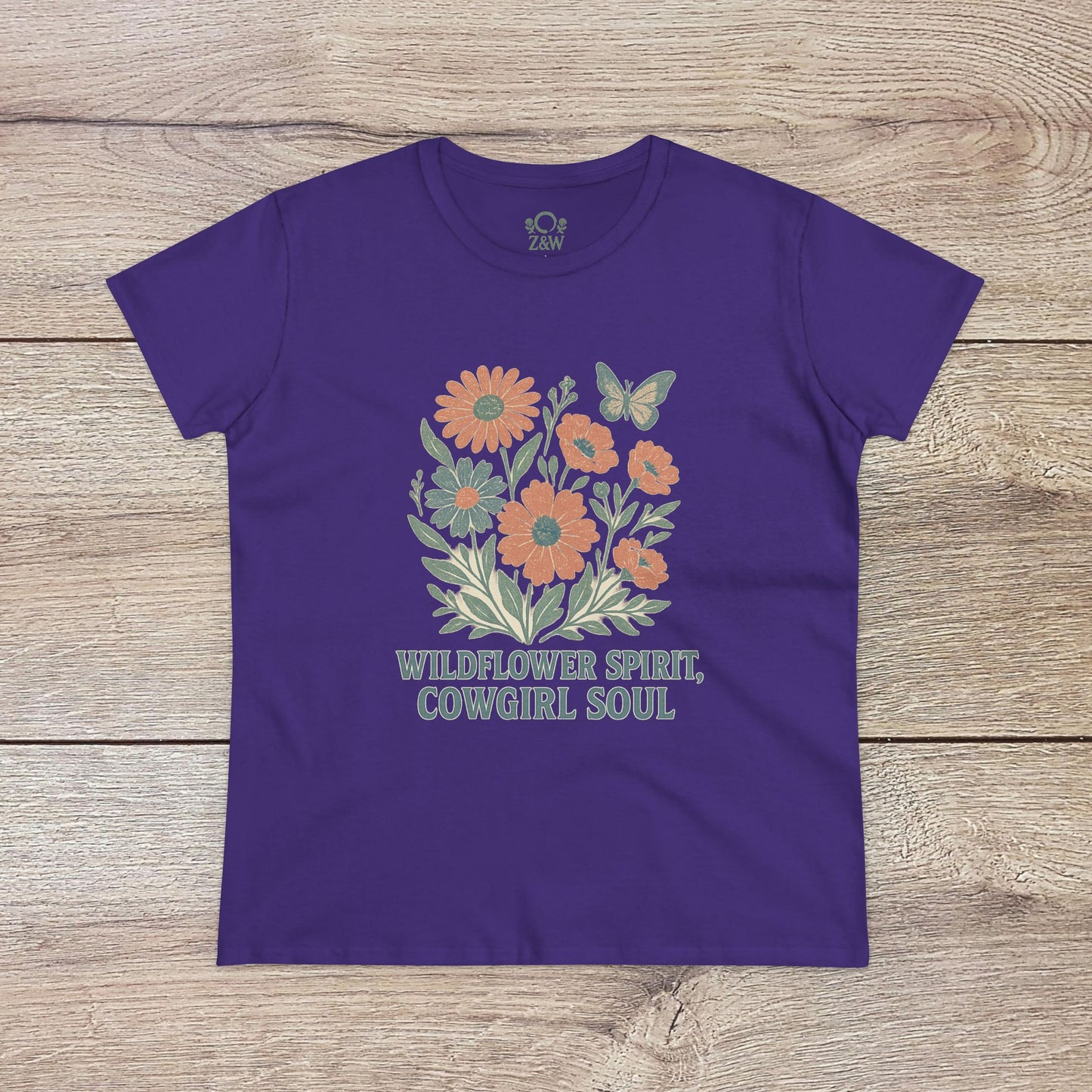 Wildflower Spirit Cotton Tee in purple with floral design and 'Wildflower Spirit, Cowgirl Soul' text, made from premium soft fabric.