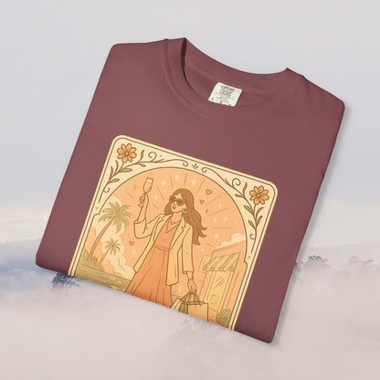 Folded Brunch Babe Tarot Graphic Tee in maroon, displaying a trendy design of a woman carrying shopping bags, a must-have for casual outfits.