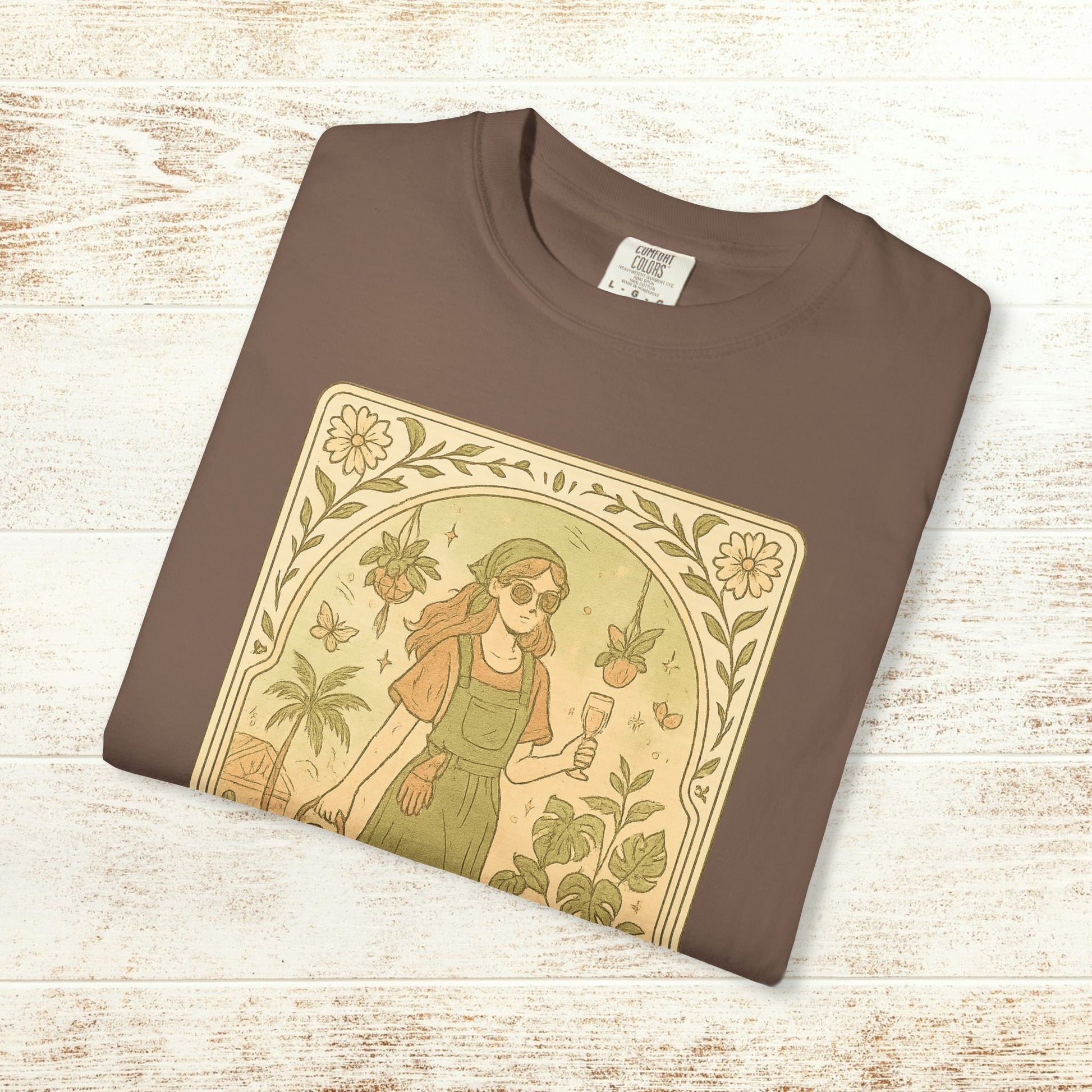 Rooted One Tarot Tee in rich brown shade showcasing a unique botanical design with a woman, plants, and butterflies - made from ethically sourced cotton, available in sizes S-4XL.